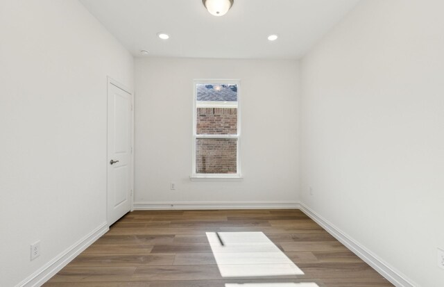 unfurnished room with hardwood / wood-style floors