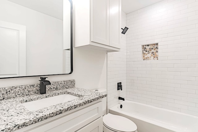 full bathroom featuring tiled shower / bath combo, vanity, and toilet