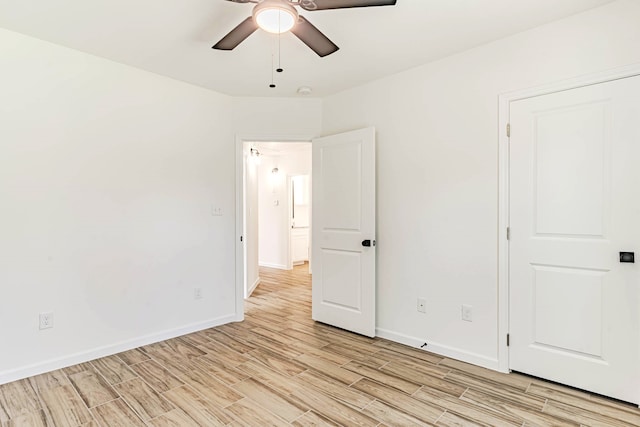 spare room with ceiling fan and light wood-type flooring