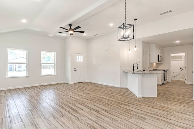 kitchen with pendant lighting, kitchen peninsula, white cabinetry, stainless steel appliances, and light hardwood / wood-style floors