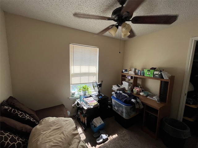 carpeted office with ceiling fan and a textured ceiling