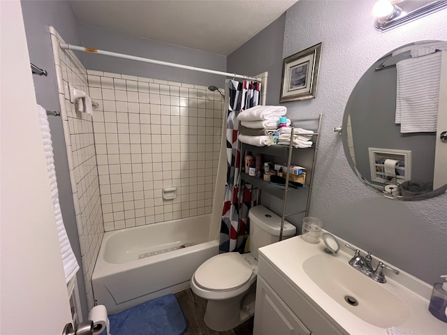 full bathroom featuring shower / tub combo, vanity, and toilet