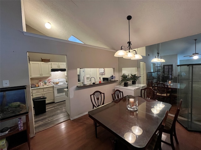 dining room with ceiling fan, a textured ceiling, dark hardwood / wood-style floors, and high vaulted ceiling