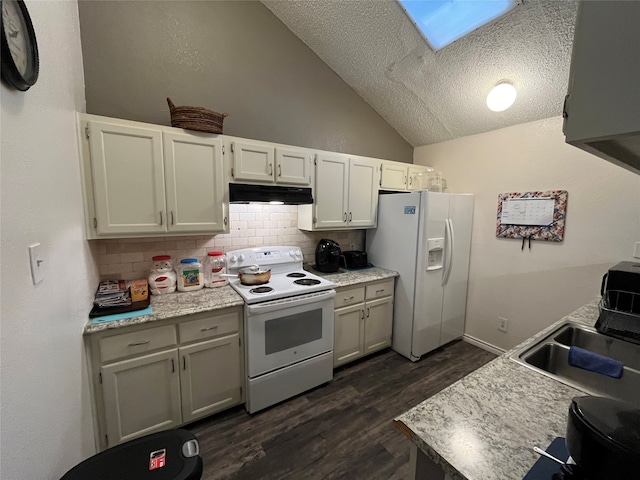 kitchen with white appliances, sink, dark hardwood / wood-style flooring, vaulted ceiling with skylight, and backsplash