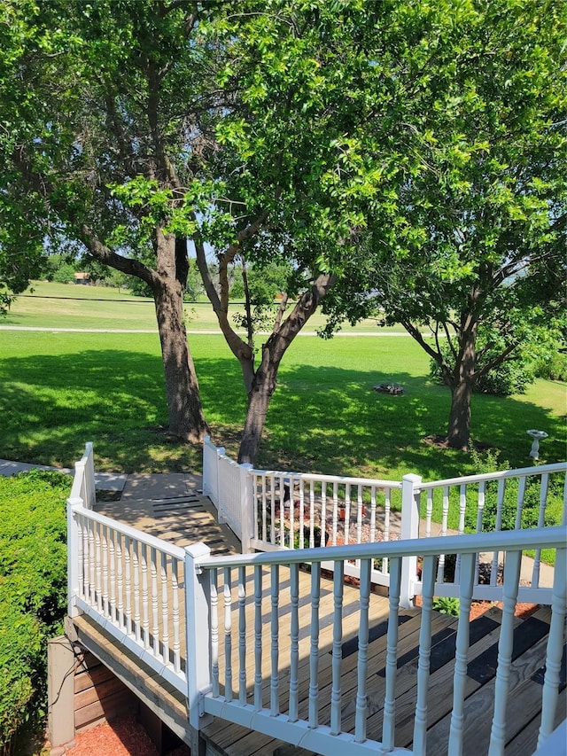 wooden terrace with a lawn