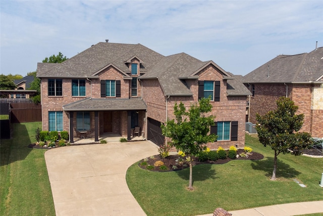 view of front of house featuring a shingled roof, concrete driveway, and brick siding