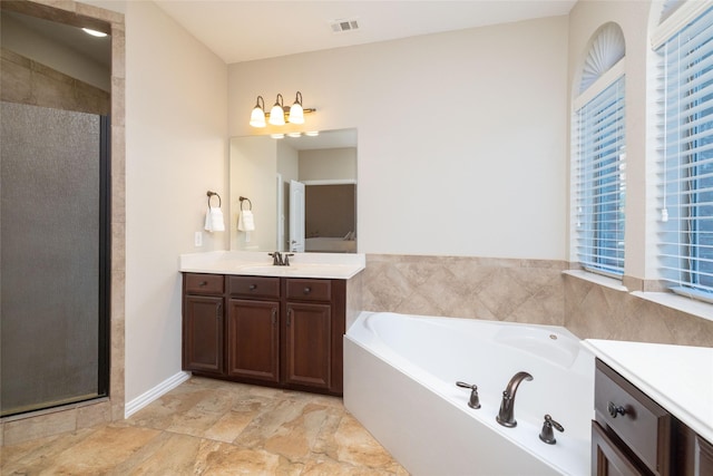 bathroom featuring vanity and separate shower and tub