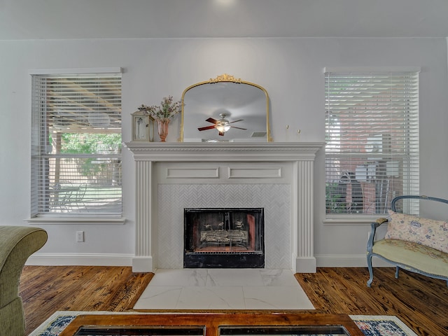 details featuring ceiling fan, a fireplace, and hardwood / wood-style floors