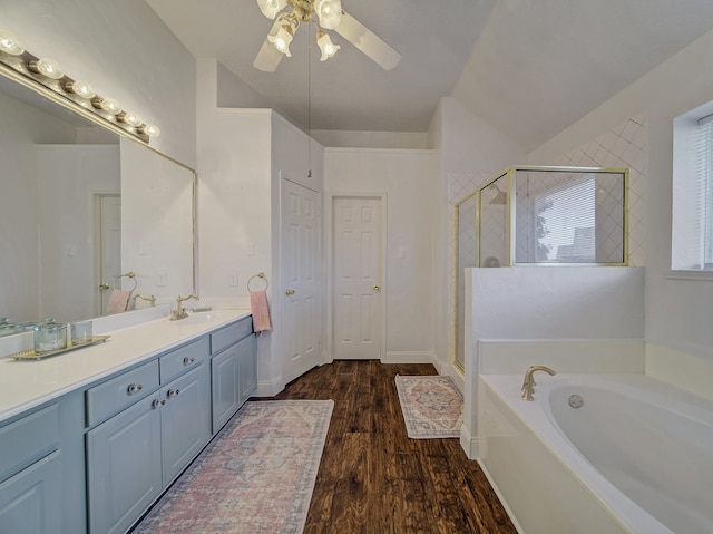 bathroom featuring ceiling fan, vanity, lofted ceiling, hardwood / wood-style flooring, and plus walk in shower