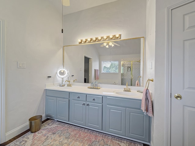 bathroom featuring vanity, lofted ceiling, and a shower with door