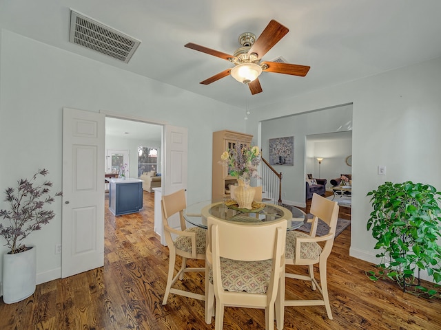 dining space with ceiling fan and hardwood / wood-style floors