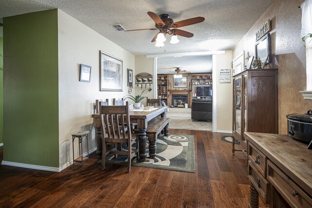 11678 S State Highway 121, Trenton, TX 75490 - dining room with ceiling fan, a fireplace, a textured ceiling, visible vents, and hardwood / wood-style flooring