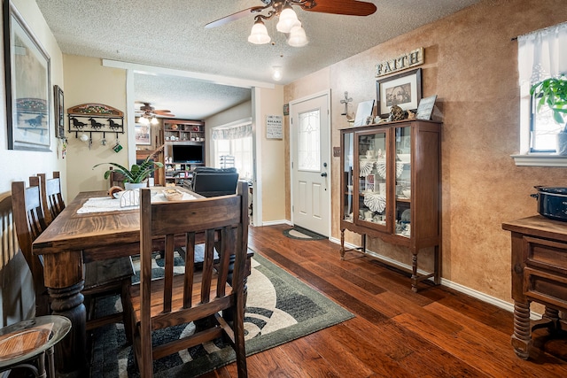 dining area with ceiling fan, dark hardwood / wood-style floors, and a textured ceiling