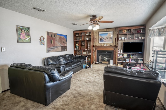 11678 S State Highway 121, Trenton, TX 75490 - carpeted living area featuring visible vents, a fireplace with raised hearth, a textured ceiling, and ceiling fan