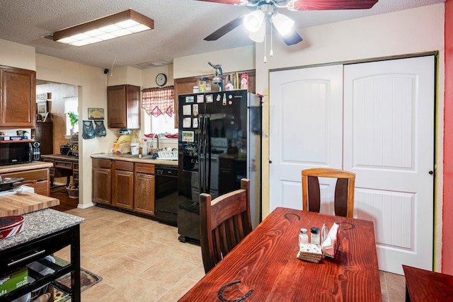 kitchen featuring black appliances, ceiling fan, sink, and a textured ceiling