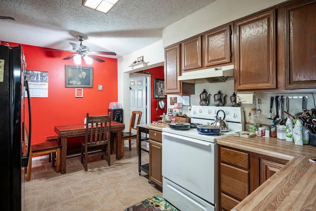 kitchen featuring ceiling fan, electric range, black refrigerator, and a textured ceiling