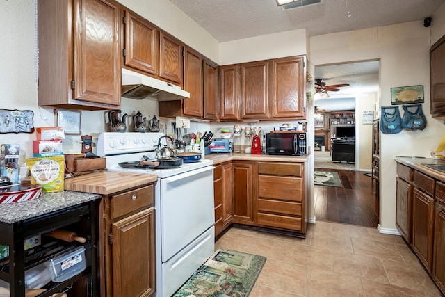 kitchen with ceiling fan, white range with electric stovetop, light wood-type flooring, and a textured ceiling