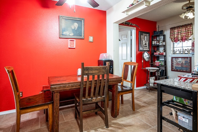 dining space with ceiling fan, a textured ceiling, and beverage cooler