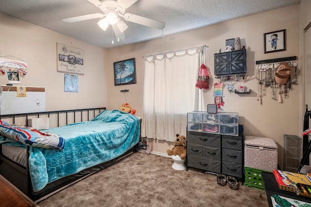 carpeted bedroom featuring ceiling fan and a textured ceiling