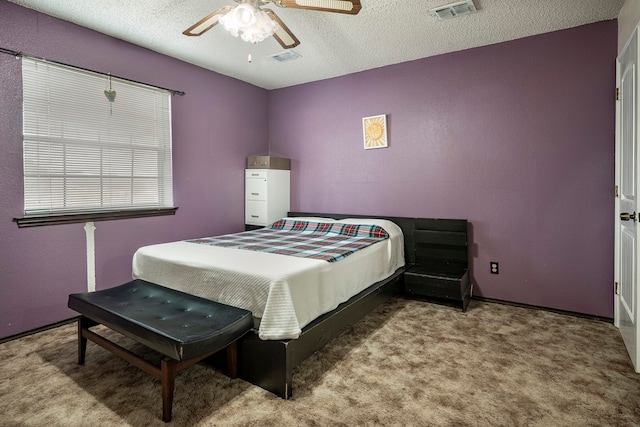 bedroom featuring carpet flooring, a textured ceiling, and ceiling fan