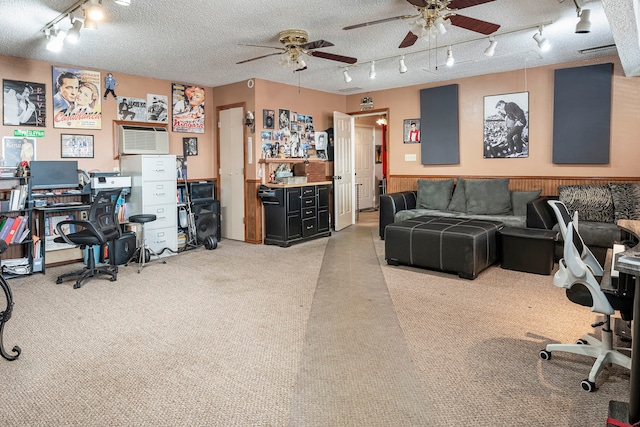 carpeted office featuring ceiling fan and a textured ceiling