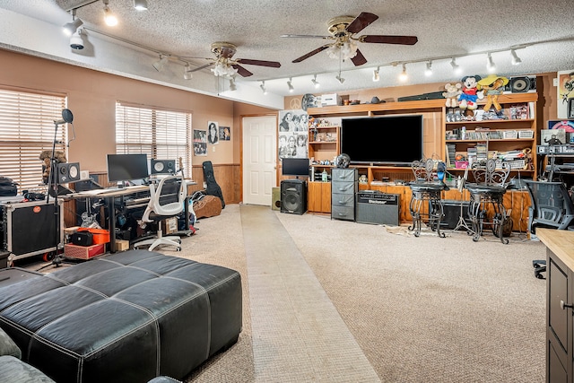 interior space featuring track lighting, carpet flooring, a textured ceiling, and ceiling fan