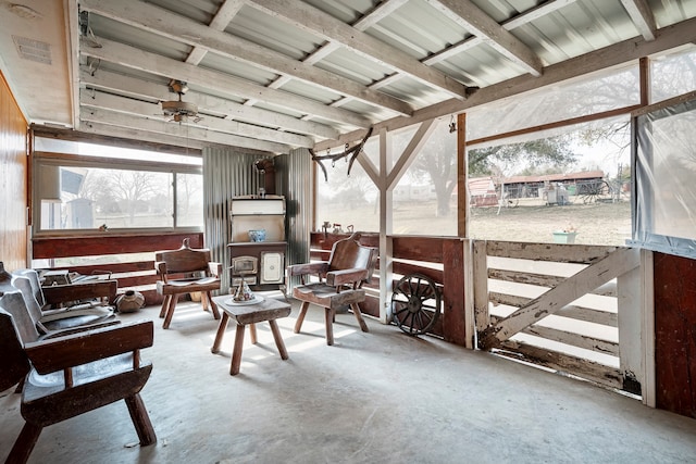 sunroom / solarium featuring ceiling fan