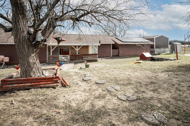 back of property featuring a storage unit