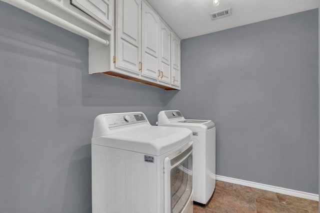 washroom with cabinets and washer and clothes dryer