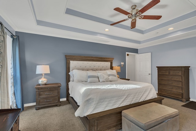 bedroom featuring carpet, a raised ceiling, ceiling fan, and ornamental molding