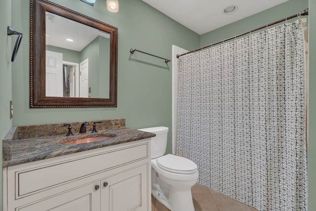 bathroom featuring tile patterned floors, vanity, a shower with shower curtain, and toilet