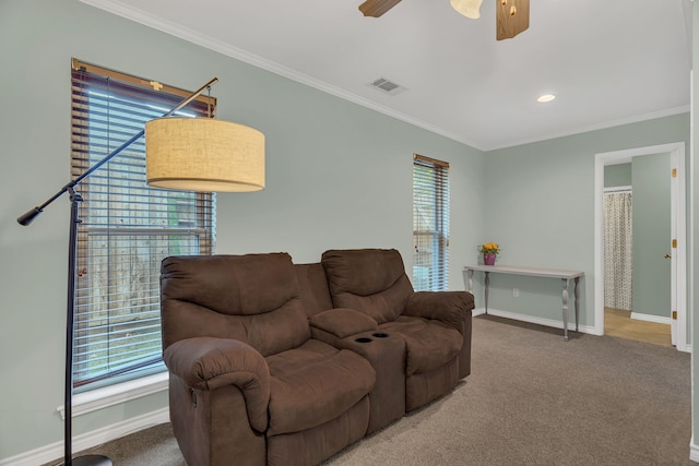 carpeted living room featuring ceiling fan and ornamental molding