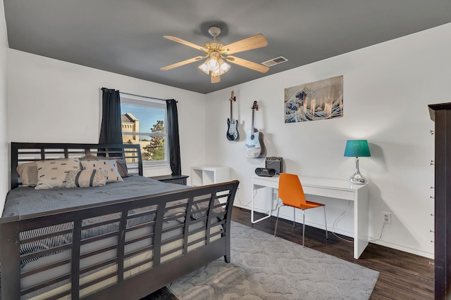 bedroom with ceiling fan and dark wood-type flooring