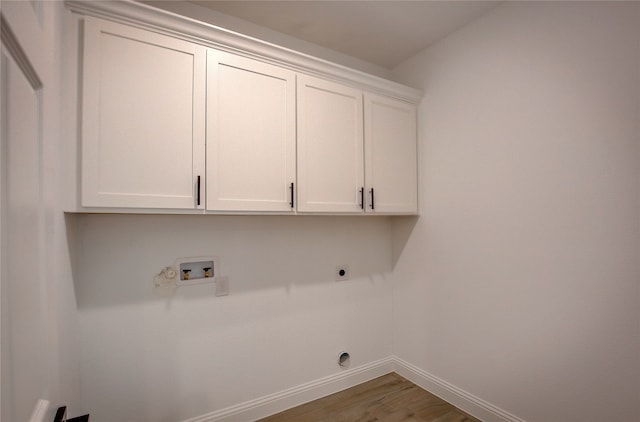 laundry area with washer hookup, hardwood / wood-style flooring, cabinets, and electric dryer hookup