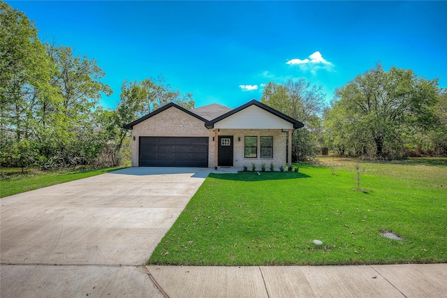 view of front of home with a garage and a front lawn