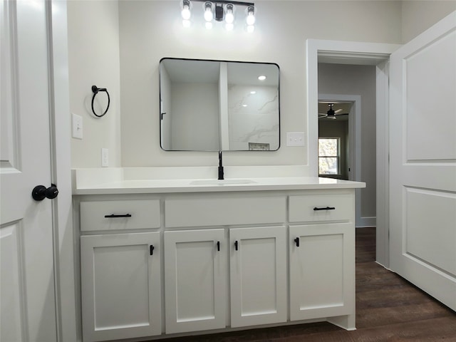 bathroom with vanity, hardwood / wood-style floors, and ceiling fan