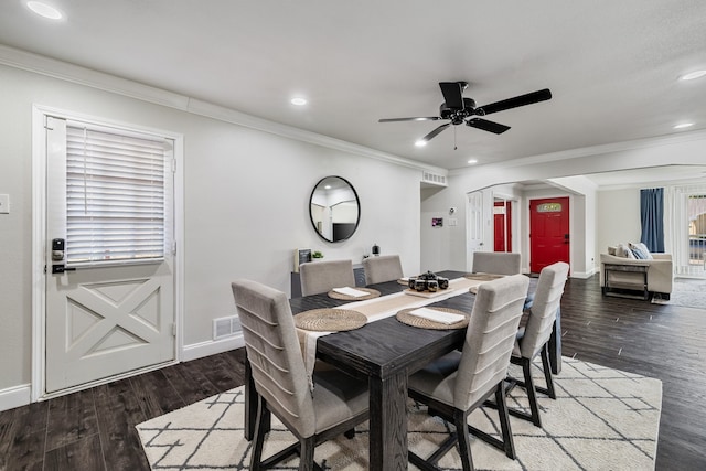 dining space featuring crown molding, dark hardwood / wood-style flooring, and ceiling fan