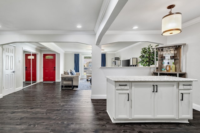 kitchen with pendant lighting, dark hardwood / wood-style flooring, light stone countertops, and white cabinets