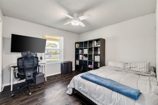 bedroom featuring a textured ceiling, ceiling fan, and dark hardwood / wood-style flooring