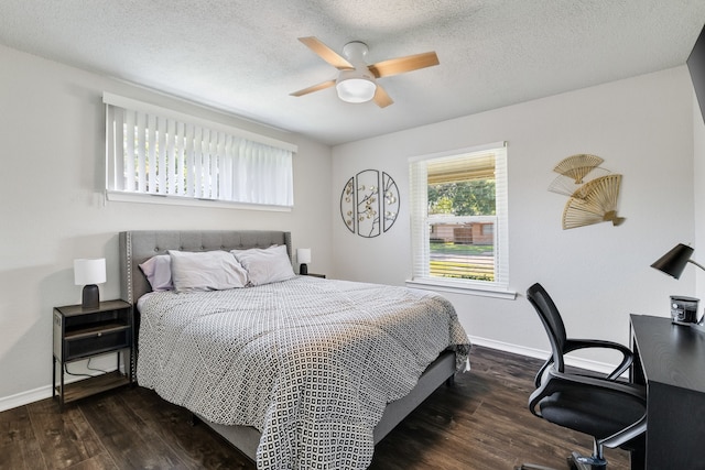 bedroom featuring dark hardwood / wood-style flooring, a textured ceiling, and ceiling fan