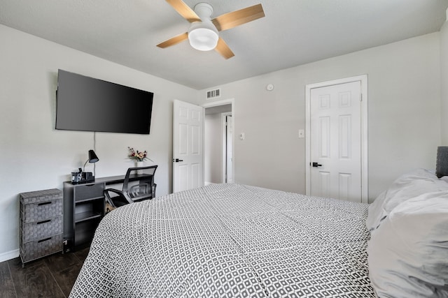 bedroom with ceiling fan and dark wood-type flooring