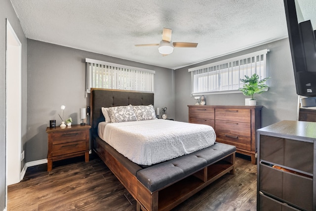 bedroom featuring ceiling fan, a textured ceiling, and dark hardwood / wood-style flooring