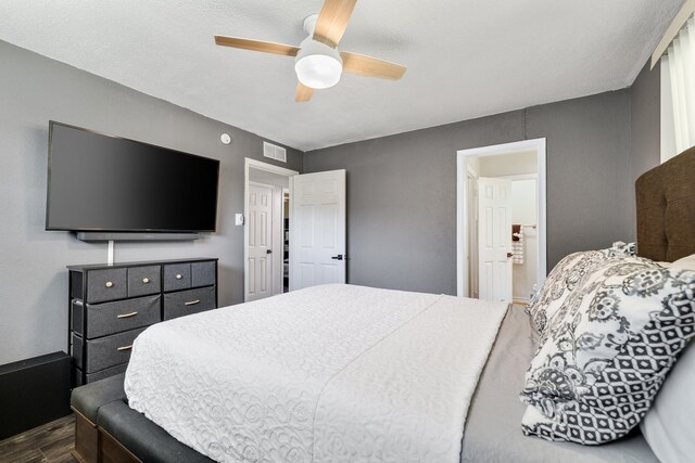 bedroom with ceiling fan and dark wood-type flooring