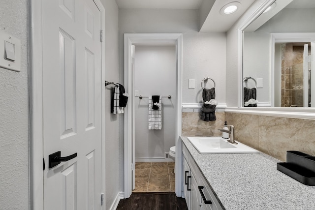 bathroom featuring hardwood / wood-style floors, vanity, and toilet