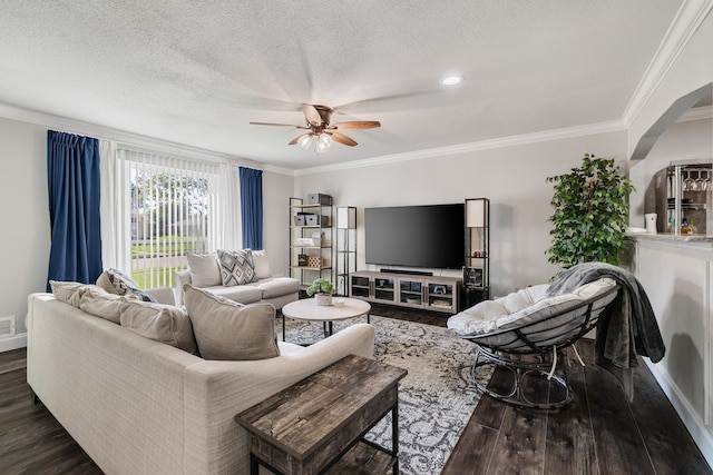 living room featuring ornamental molding, ceiling fan, dark wood-type flooring, and a textured ceiling