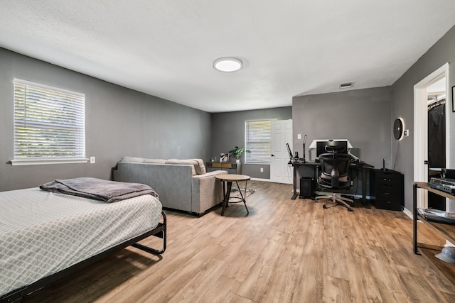 bedroom with light hardwood / wood-style floors