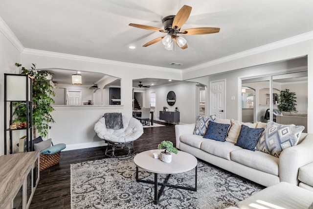 living room with ornamental molding, ceiling fan, and dark hardwood / wood-style flooring