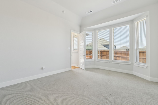 unfurnished room featuring light carpet, baseboards, and visible vents