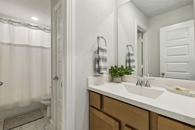 bathroom with toilet, marble finish floor, shower / bath combo with shower curtain, and vanity