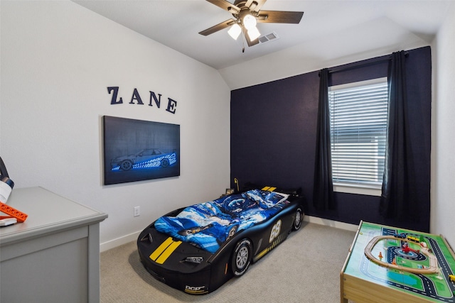 carpeted bedroom featuring visible vents, baseboards, vaulted ceiling, and a ceiling fan